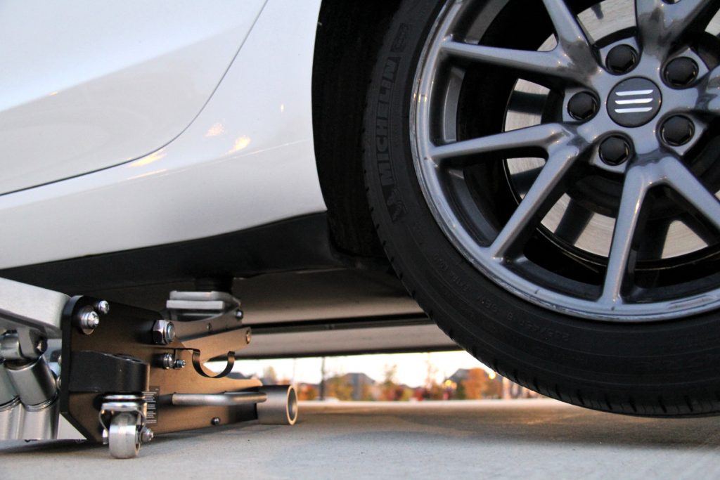 Model 3/Y lifted using a jack
