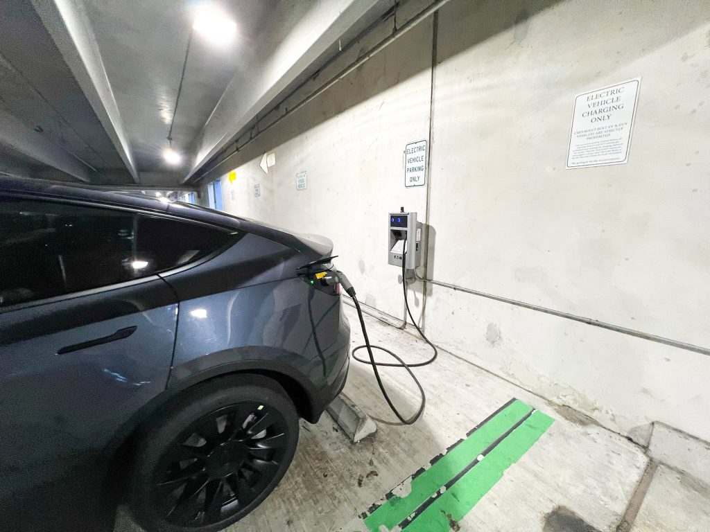 Midnight Silver Metallic Colour Tesla Model Y Charging in a Parking Garage