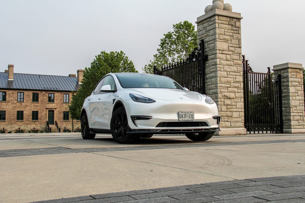 Pearl White Tesla Model Y with a Carbon Fiber Body Kit