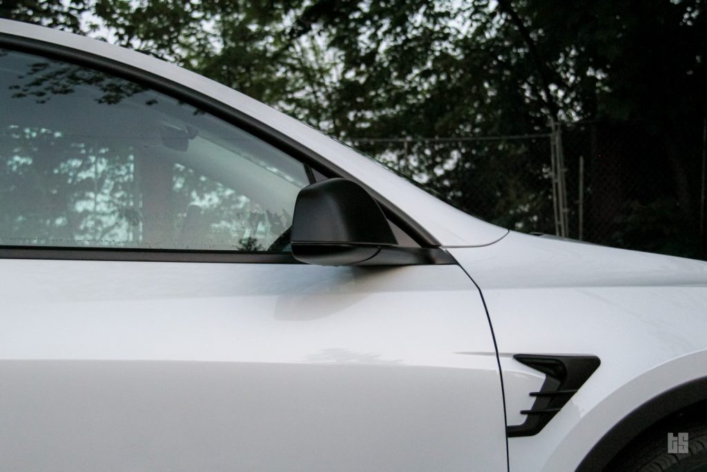 Tesloid's Side Mirror Cover on a Pearl White Tesla Model Y