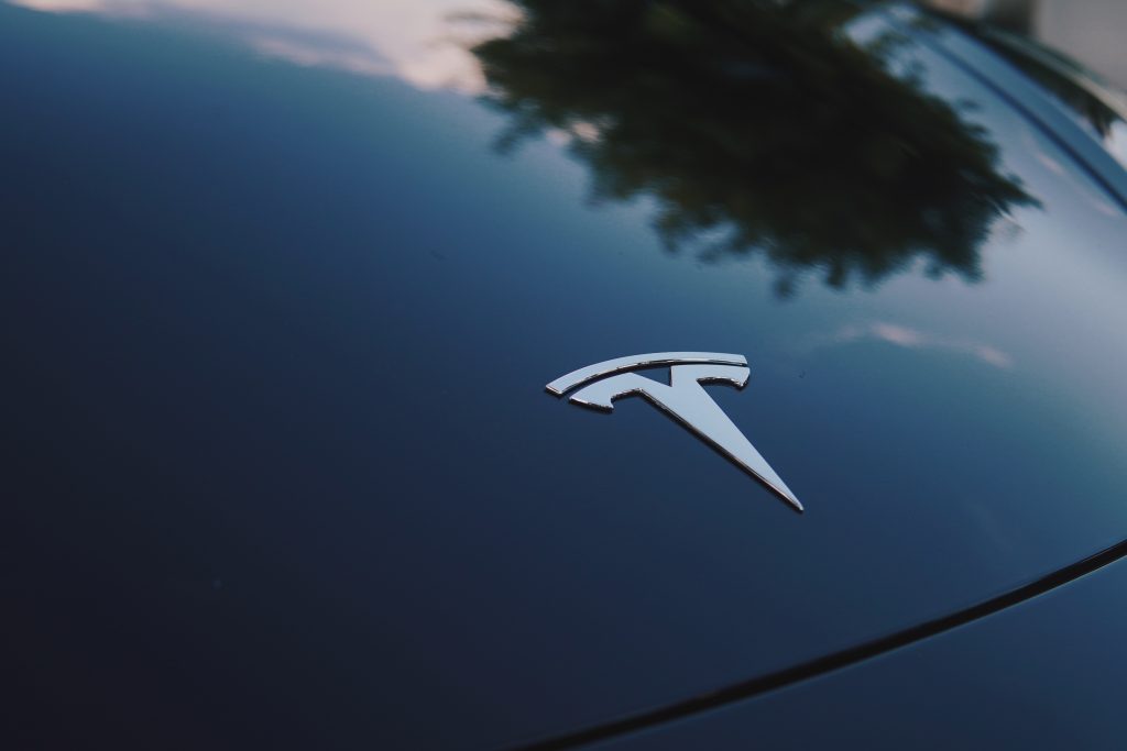 The Hood of a Tesla with the Tesla Emblem