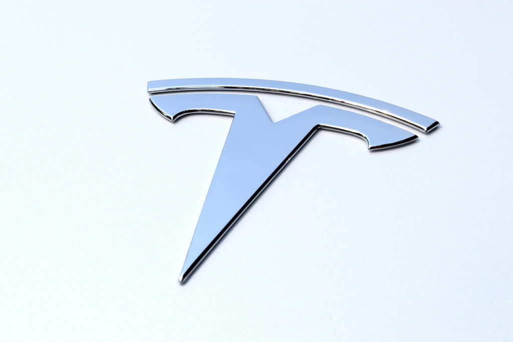 Chrome Tesla Emblem on the Pearl White Paint