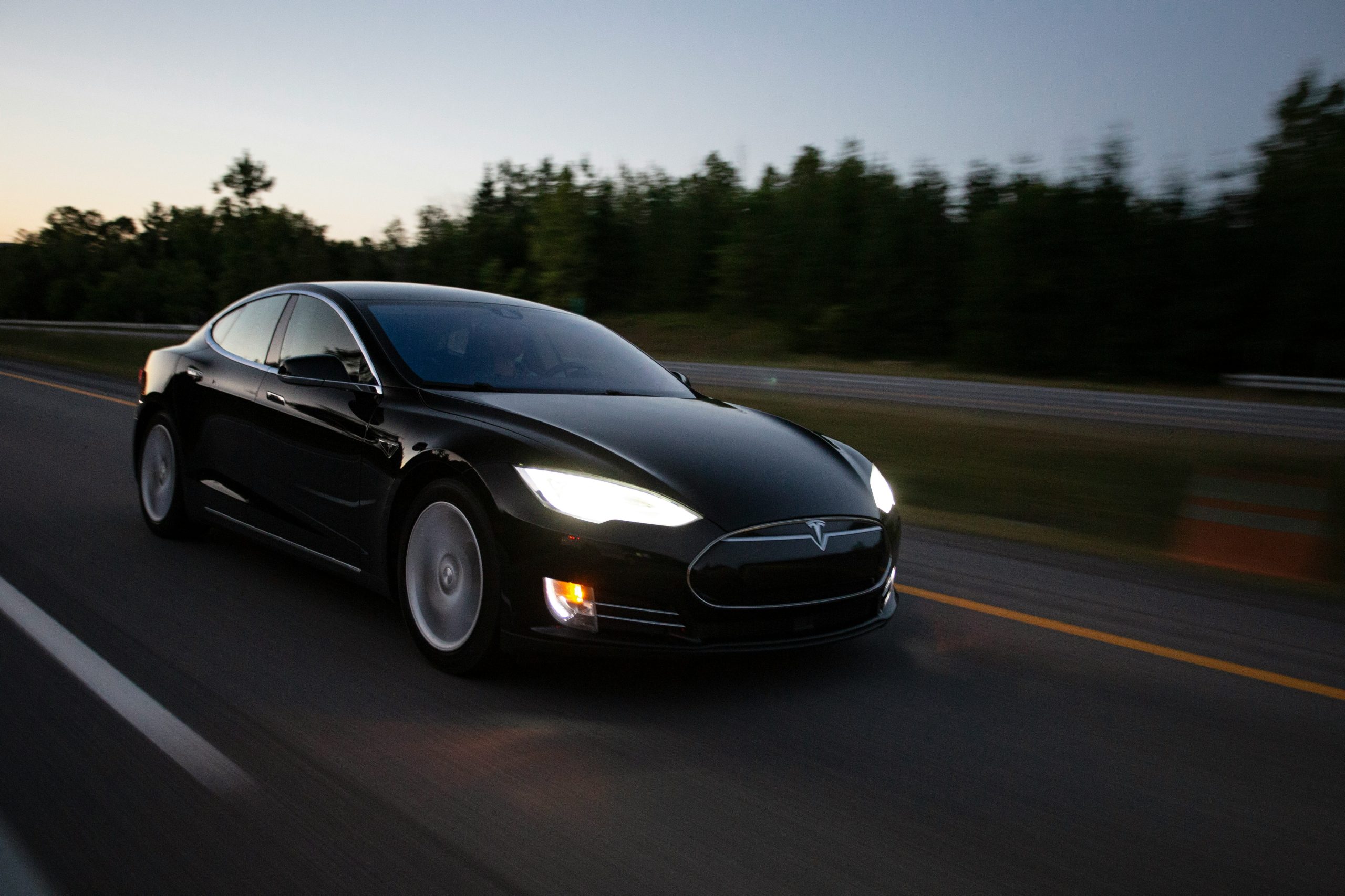 Tesla Model S Driving Down a Road at a Fast Speed