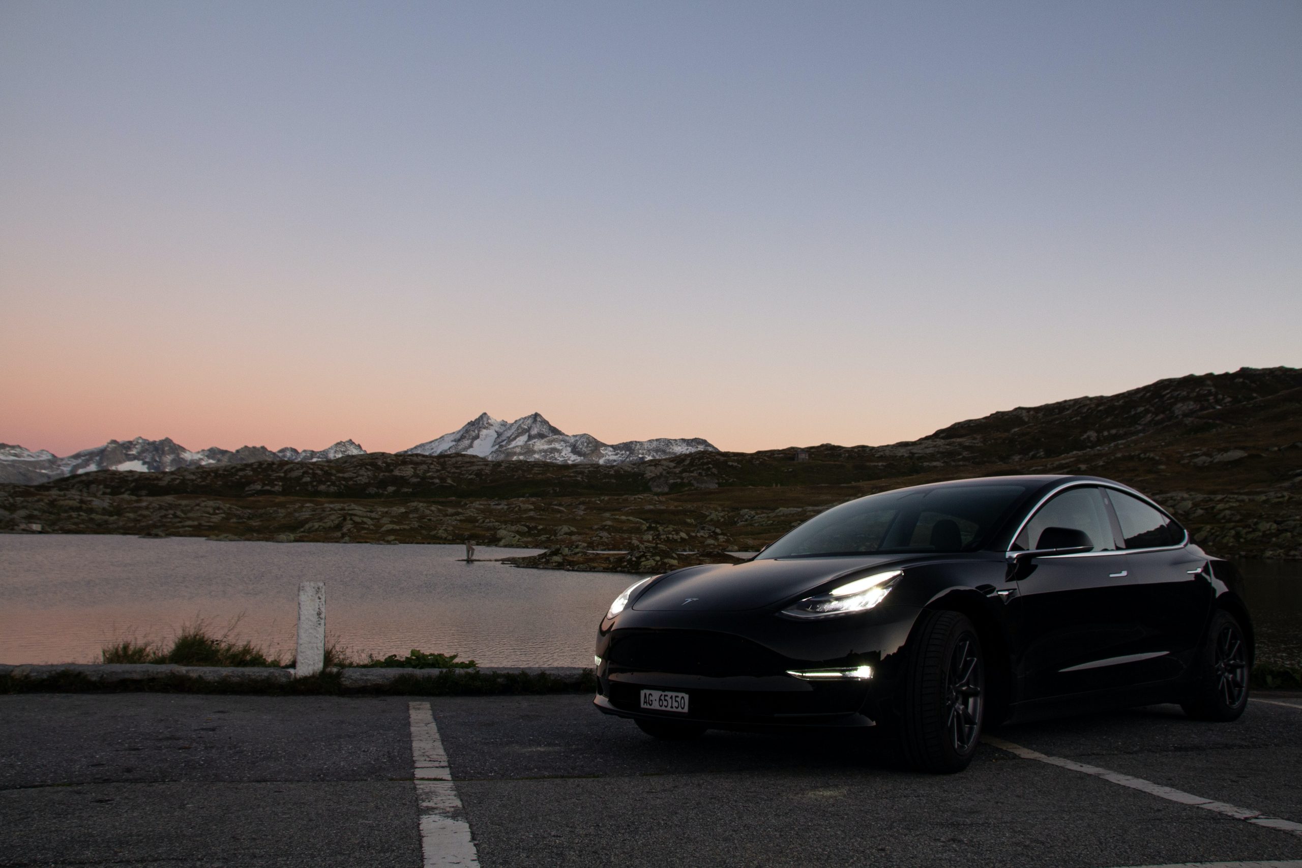 Gray Tesla Model 3 with Headlights on